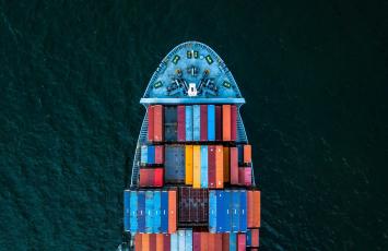 Drone picture of ship with colorfull cargo